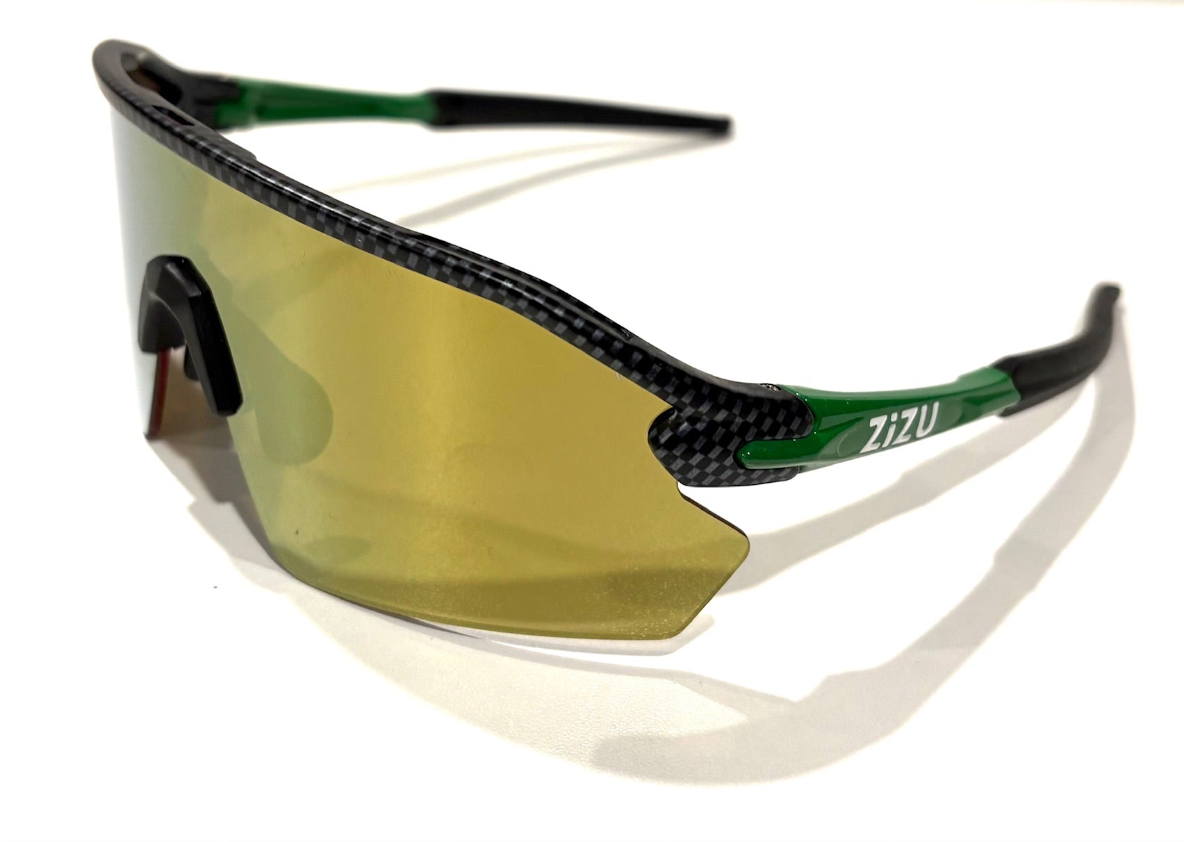 Sunglasses with carbon fiber frame and gold lenses on a white background